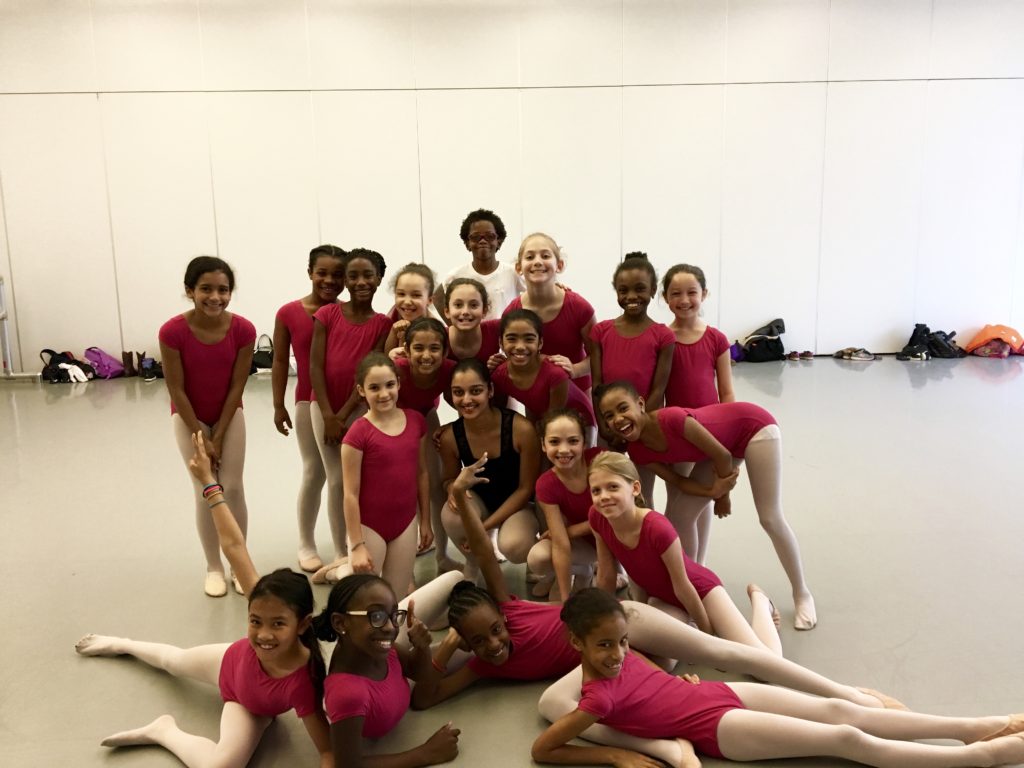 A group of young ballerinas posing for a picture.