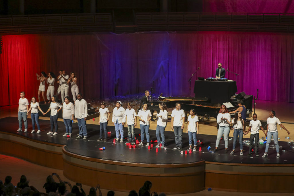 A group of people on stage singing.