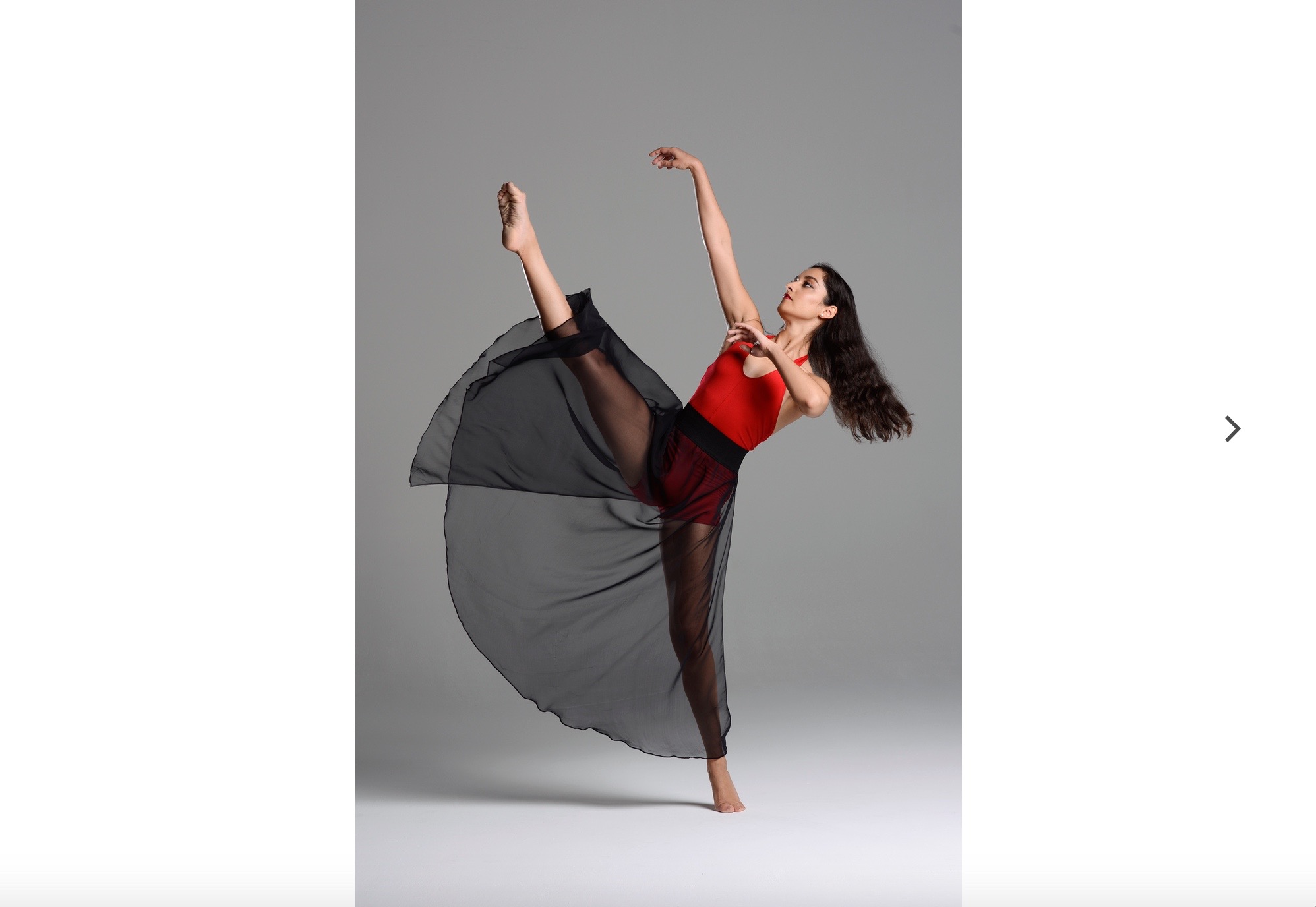 A woman in red and black dress dancing