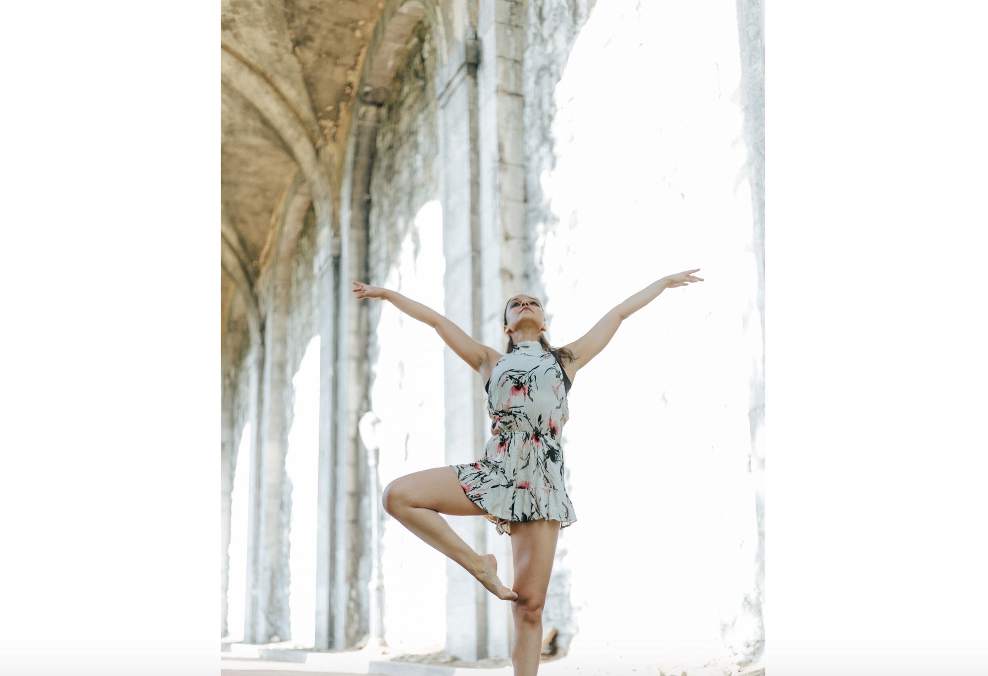 A woman in a floral dress doing yoga