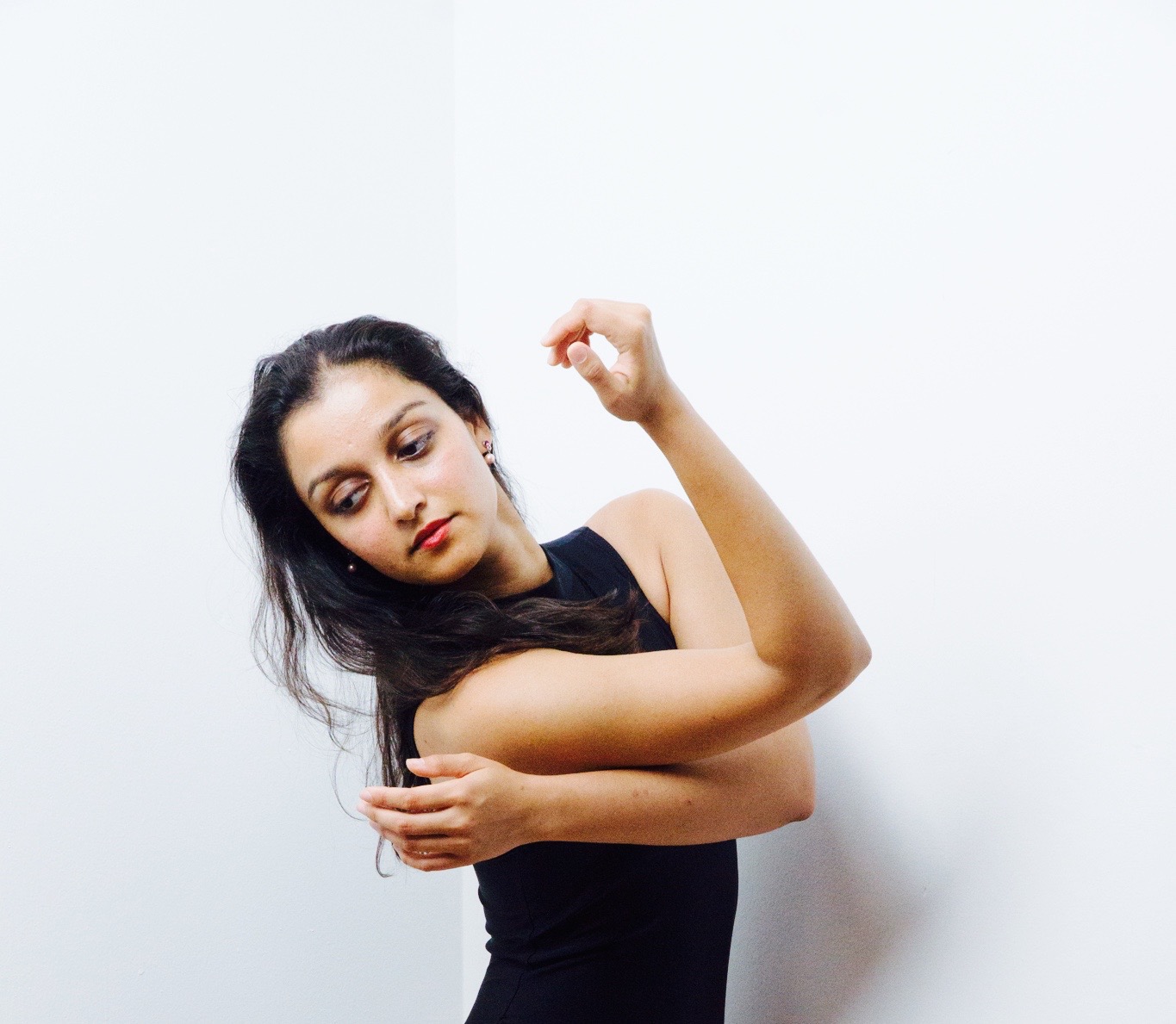 A woman in black shirt holding her arm up.