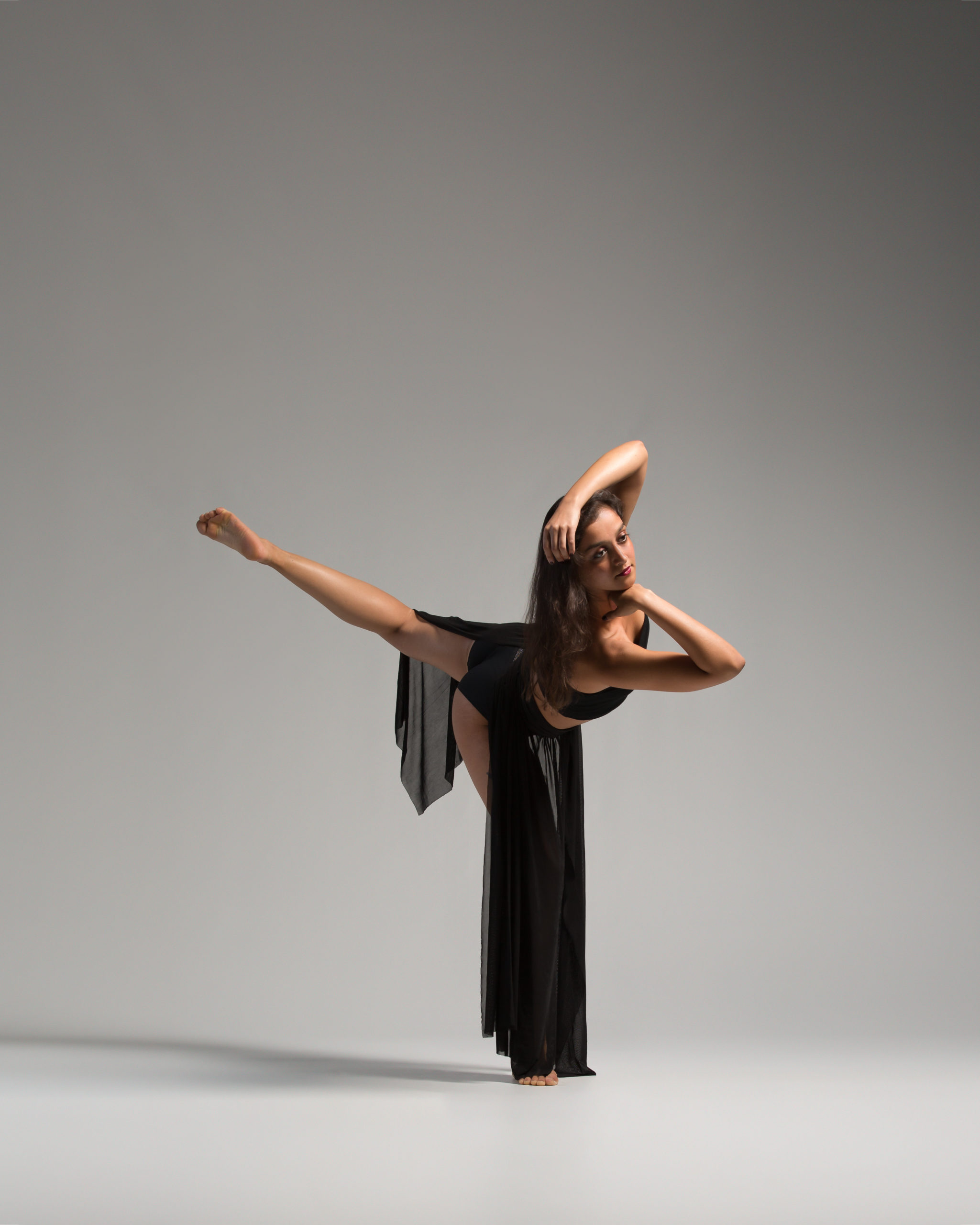 A woman in black dress doing a dance move.