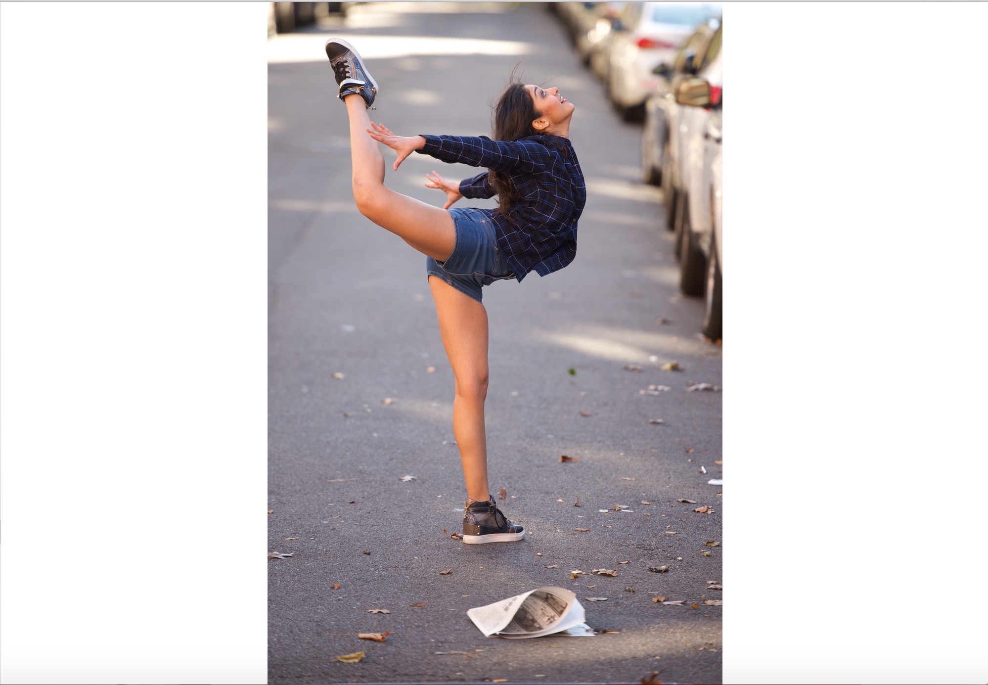 A girl is doing a trick on the street