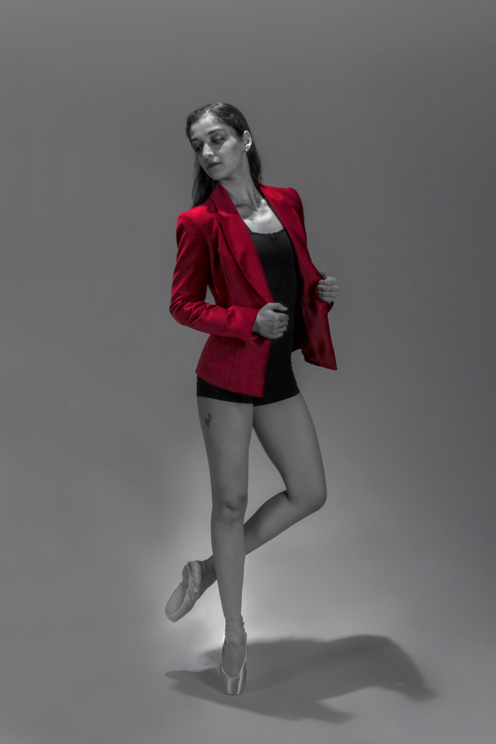 A woman in black and white with red jacket.